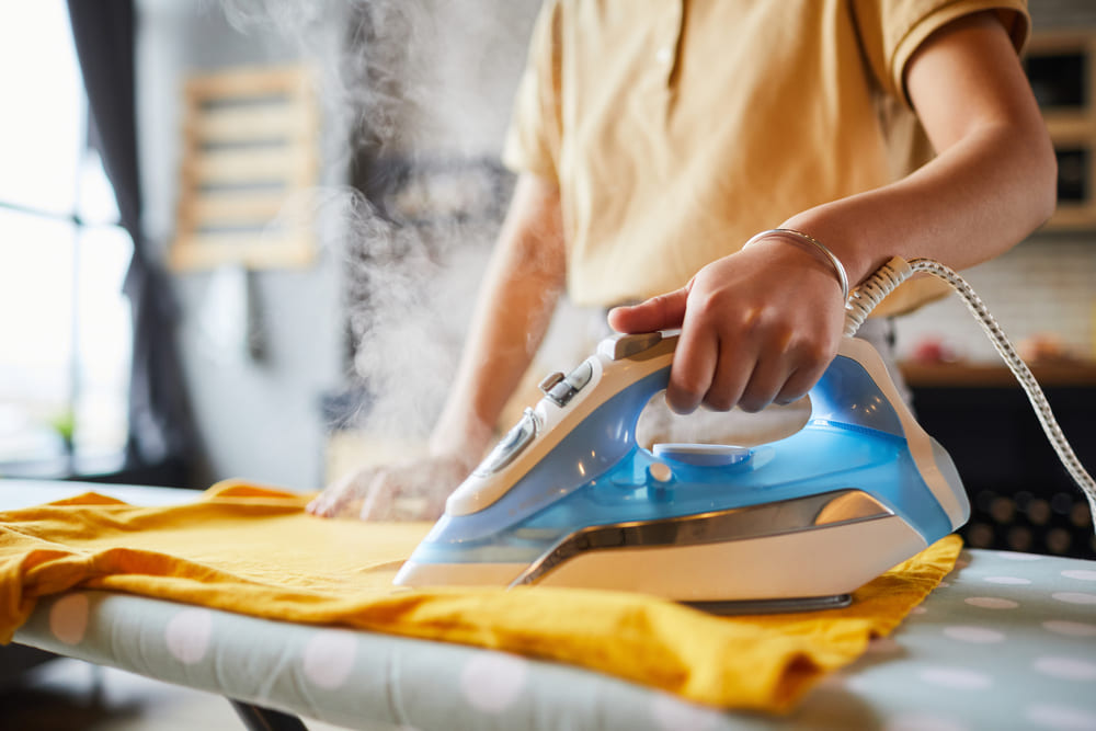 young-woman-ironing-close-up-2023-11-27-05-05-21-utc